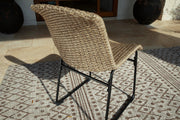 Set of two Ashley Furniture Amaris outdoor dining chairs with metal frames and fabric cushions, ideal for outdoor patio dining.
