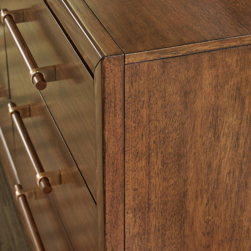 Ashley Furniture Lyncott dresser with matching mirror, wooden finish, and modern design, shown in a well-lit bedroom setting.