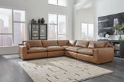 Ashley Furniture Emilia Leather Sectional with matching ottoman, featuring plush cushions and sleek leather upholstery.