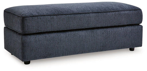 Oversized Ashley Furniture Albar Place accent ottoman with plush fabric and wooden legs, serving as a stylish interior accent piece.