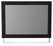 Ashley Furniture Belachime bedroom mirror with a sleek, modern design, reflecting a stylish bedroom setting.