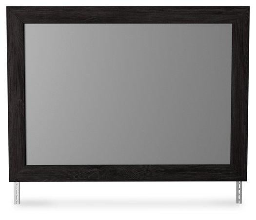 Ashley Furniture Belachime bedroom mirror with a sleek, modern design, reflecting a stylish bedroom setting.