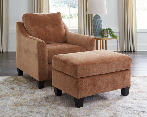 Ashley Furniture Amity Bay living room set with sofa, loveseat, and armchair in a modern design, shown in a cozy living space.
