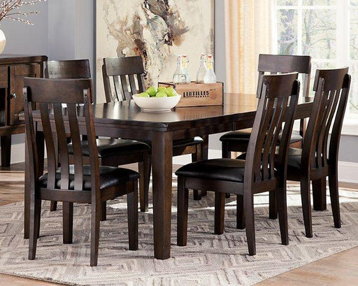 Ashley Furniture Haddigan Dining Set with a wooden table and six matching chairs in a modern dining room.