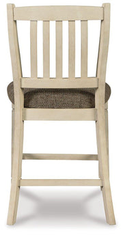 Counter height Ashley Furniture Bolanburg barstool with wood legs and cushioned seat, ideal for kitchen or bar area.