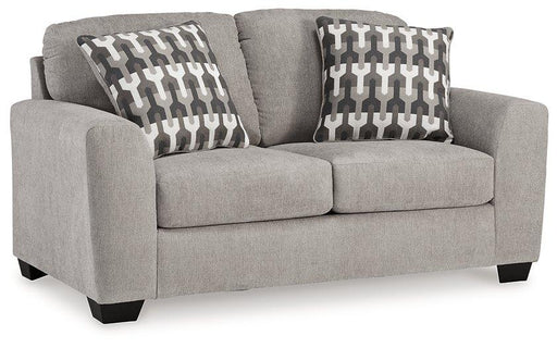 Avenal Park loveseat by Ashley Furniture featuring plush beige upholstery and cushioned armrests in a cozy living room setting.