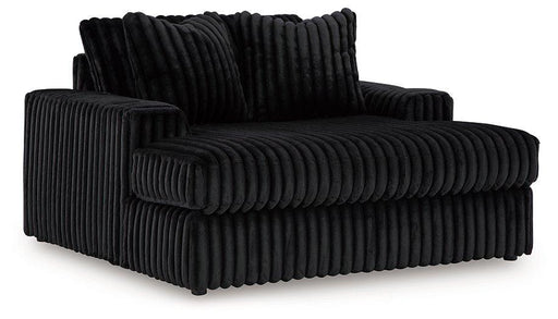 Oversized Midnight-Madness Ashley Furniture chair with plush upholstery and wide, comfortable seating in a modern living room setting.