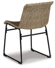 Two Ashley Furniture Amaris outdoor dining chairs with metal frames and beige cushions, set against a garden background.