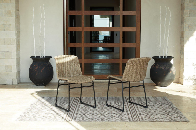 Set of two Ashley Furniture Amaris outdoor dining chairs with metal frames and cushioned seats for patio dining.