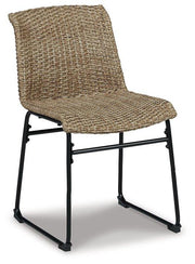 Pair of Ashley Furniture Amaris outdoor dining chairs with metal frames and woven seats, set against a garden background.