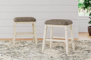 Ashley Furniture Bolanburg counter height bar stool with cushioned seat and wooden legs, shown in a modern kitchen setting