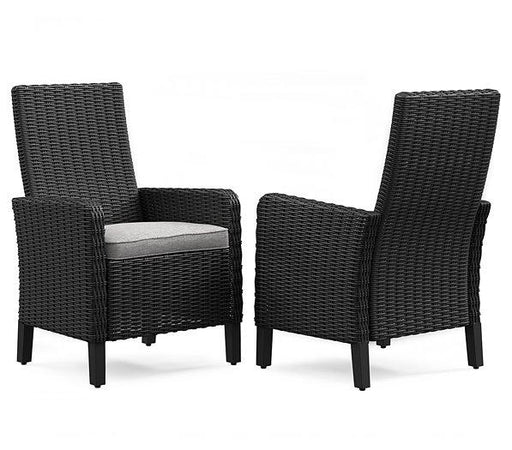 Set of two Ashley Furniture Beachcroft outdoor dining arm chairs with cushions, featuring a stylish outdoor seating design.