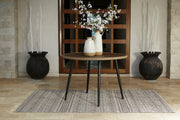 Outdoor dining table by Ashley Furniture with a rectangular wooden surface and sturdy metal legs for outdoor use.