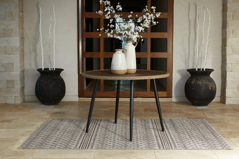 Outdoor dining table by Ashley Furniture with a rectangular wooden surface and sturdy metal legs for outdoor use.