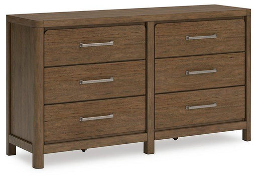 Ashley Furniture Cabalynn Dresser with multiple drawers, crafted in wood with a modern design, placed in a bedroom setting.