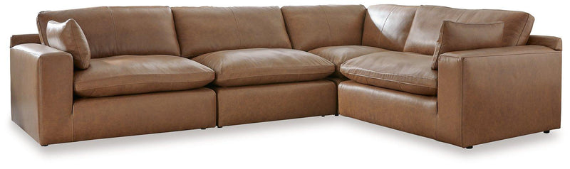Comfortable Ashley Furniture Emilia Sectional sofa with plush cushions and neutral fabric, shown in a modern living room setting.