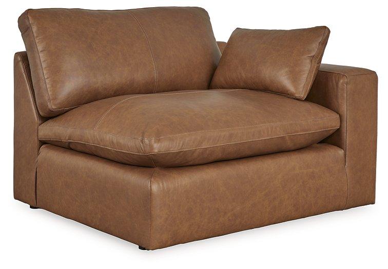 Ashley Furniture Emilia Sectional sofa with plush cushions and neutral upholstery in a modern living room setting.