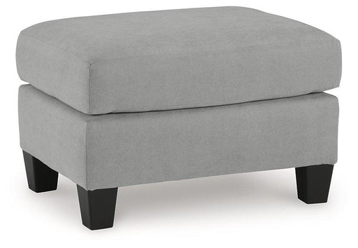 Ashley Furniture Adlai Ottoman in neutral fabric with cushioned top and wooden legs, ideal for living room or lounge decor.