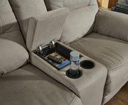 Ashley Furniture Next-Gen Gaucho Reclining Loveseat with console, featuring plush upholstery and built-in armrest storage.