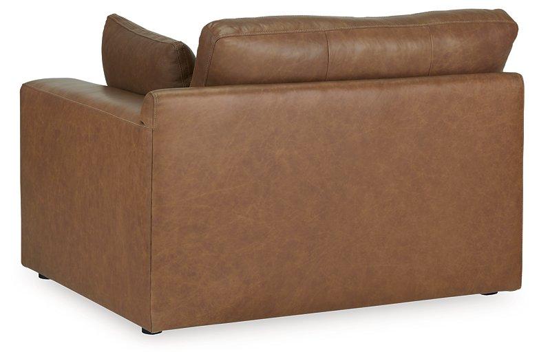 Comfortable Ashley Emilia Sectional sofa with plush cushions and neutral fabric, shown in a modern living room setting.