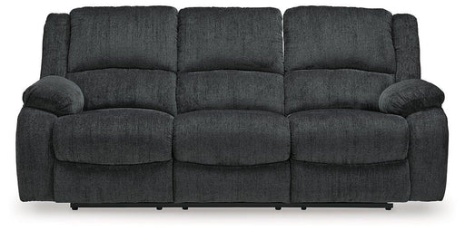 Ashley Furniture Draycoll reclining sofa with plush cushions and reclining features, shown in a cozy living room setting.