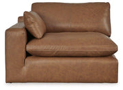 Ashley Furniture Emilia Sectional sofa with plush cushions and neutral upholstery in a modern living room setting.