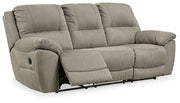 Ashley Furniture Next-Gen Gaucho Reclining Sofa showing plush beige fabric, padded armrests, and reclining sections for comfort.