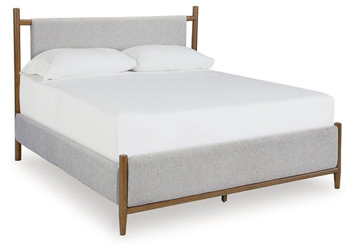 Ashley Furniture Lyncott upholstered bed with a padded headboard and fabric upholstery, shown in a modern bedroom setting.