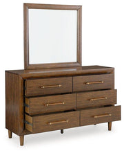 Ashley Furniture Lyncott dresser with matching mirror, featuring a modern wood finish and sleek design for bedroom storage.