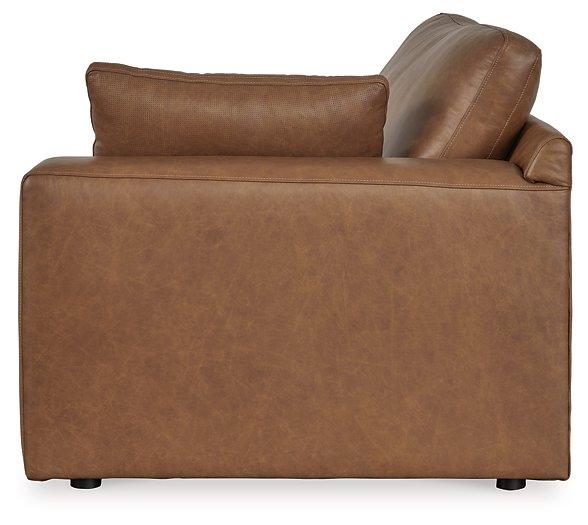 Emilia sectional sofa by Ashley Furniture with plush cushions and modern design in a neutral fabric finish.