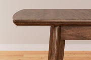Ashley Furniture Lyncott Dining Extension Table with wood finish, showcasing its extendable design and sturdy construction.