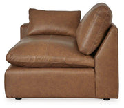 Ashley Furniture Emilia Sectional sofa with plush cushions and neutral fabric, arranged in a modern living room setting.