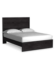 Ashley Furniture Belachime Bedroom Set featuring a bed, dresser, and nightstands in a modern bedroom decor setting.