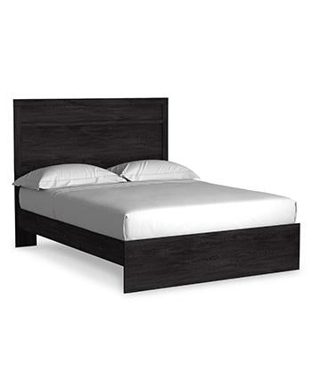 Ashley Furniture Belachime Bedroom Set featuring a bed, dresser, and nightstands in a modern bedroom decor setting.