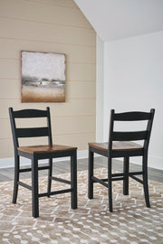 Ashley Furniture Valebeck counter height barstool with a cushioned seat and wooden legs, ideal for kitchen or bar area.