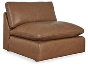 Ashley Furniture Emilia Leather Sectional with matching ottoman in a spacious living room setting.