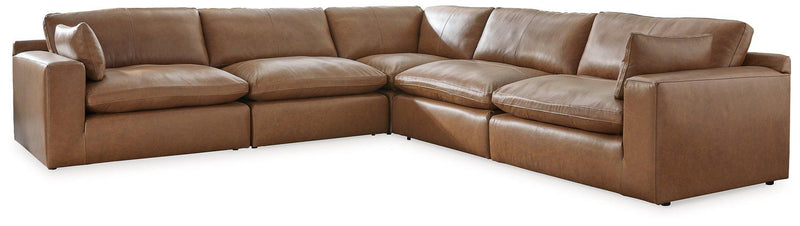 Ashley Furniture Emilia Sectional sofa with plush cushions and modern design in a neutral fabric.