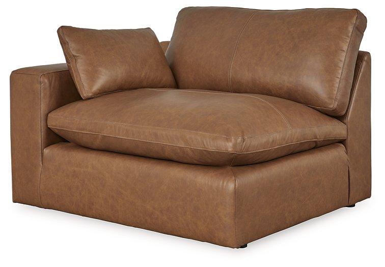 Ashley Furniture Emilia Sectional sofa with plush cushions and modern design, shown in a neutral fabric in a stylish living room setting.