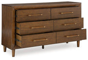 Ashley Furniture Lyncott dresser and mirror set with a sleek wooden dresser and matching mirror in a modern bedroom style.