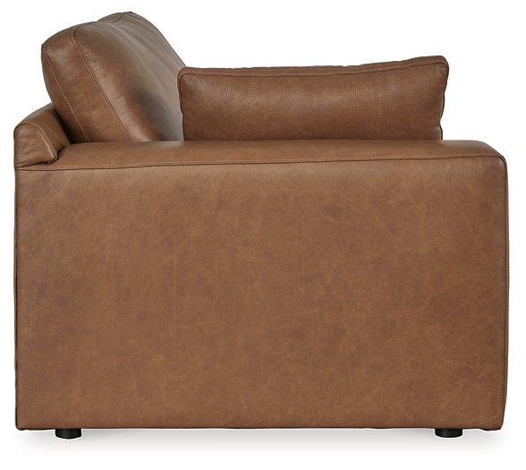Ashley Furniture Emilia Sectional sofa with plush cushions and modern design, shown in a cozy living room setting.