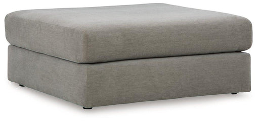 Ashley Furniture Avaliyah oversized accent ottoman with plush fabric and modern design, shown as a versatile living room decor piece.