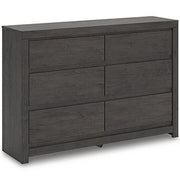 Ashley Furniture Fraluna Dresser with multiple drawers and modern wood finish, displayed in a contemporary bedroom setting.