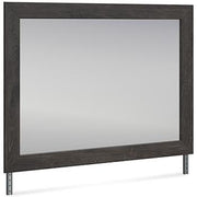 Ashley Furniture Fraluna bedroom mirror with a sleek, modern design and a rectangular shape, hanging on a wall in a bedroom setting.