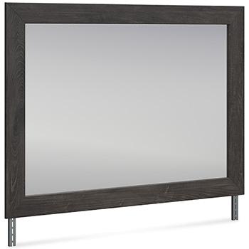 Ashley Furniture Fraluna bedroom mirror with a sleek, modern design and a rectangular shape, hanging on a wall in a bedroom setting.