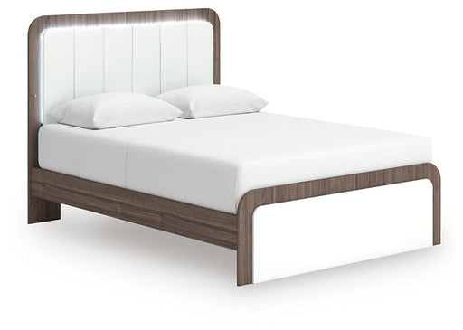 Ashley Furniture Kendanport upholstered bed with a plush, padded headboard and stylish design, shown from an angled side view.