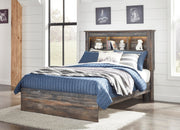 Ashley Furniture Drystan Youth Bed showing a sturdy wooden frame with a classic design in a well-lit bedroom setting.