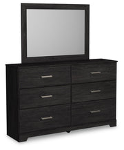 Ashley Furniture Belachime bedroom set shown from an angle, featuring a modern bed frame, nightstands, and matching bedroom furniture.