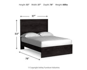 Ashley Furniture Belachime bed with a dark wood frame and upholstered headboard, shown in a bedroom setting.