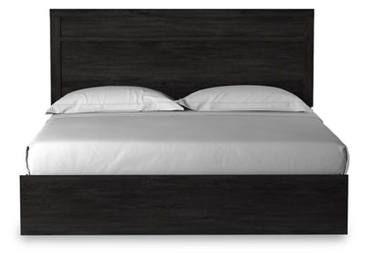 Ashley Furniture Belachime Bed with headboard featuring detailed woodwork and a rich finish, shown from a head-on view.
