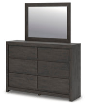 Ashley Furniture Fraluna bedroom set includes a bed with a padded headboard and matching nightstands in a stylish bedroom scene.